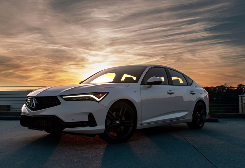 White Acura parked during sunset